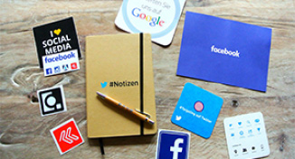 Image of Pieces of paper advertising Facebook, Twitter and Google